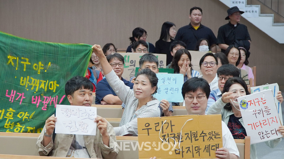 향린교회에서 열린 기후 정의 주일 연합 예배에 참석한 그리스도인들이 다양한 문구가 적힌 피켓을 들고 있다. 뉴스앤조이 엄태빈